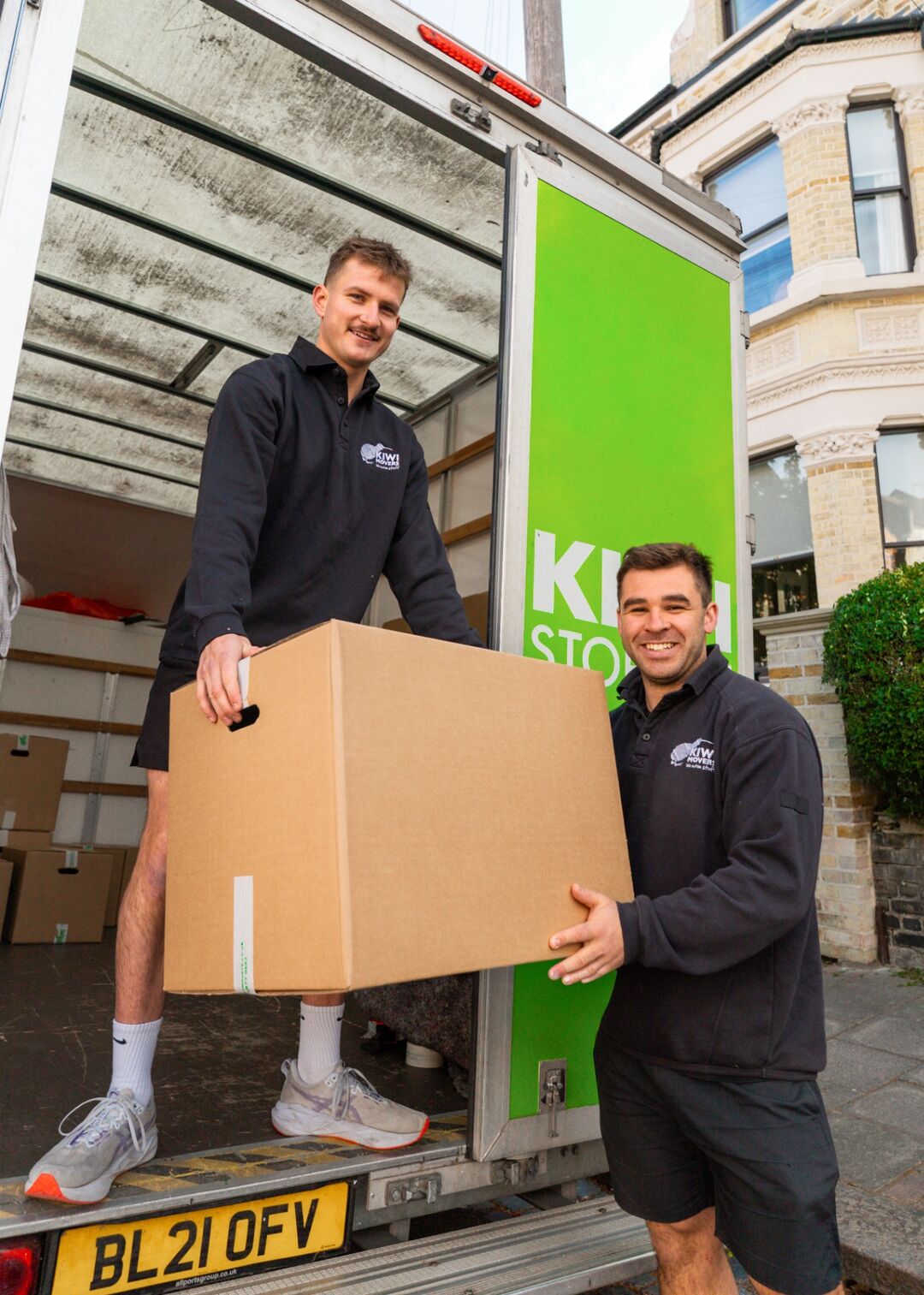 Kiwi Movers team loading a customer's boxes into the truck